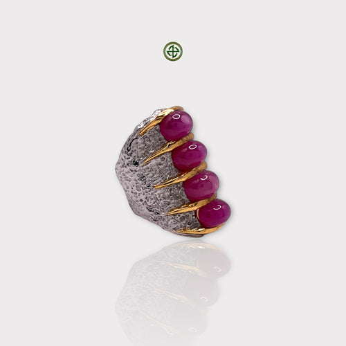 A solid silver ring with multiple red ruby gemstones set in an elegant design, with a textured band and polished finish.