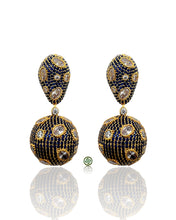 Pair of gold and blue earrings on a white background