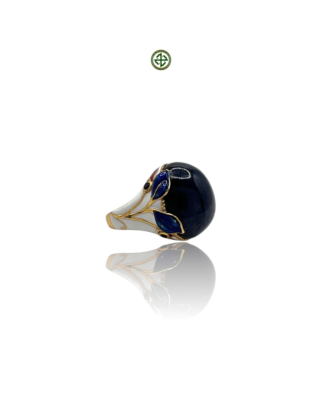 An enamel statement ring featuring a star sapphire center stone with gold vermeil plating and blue, red, and white enamel details.