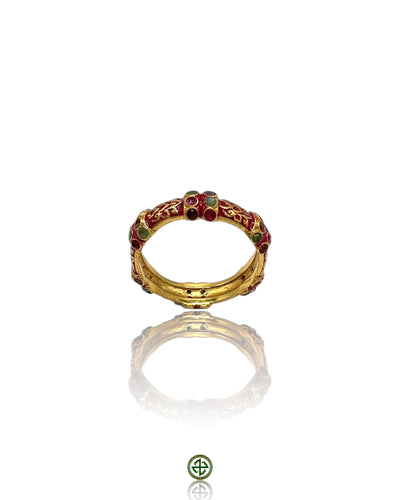 A Stucky-style eternity ring with red enamel and alternating ruby, emerald, and amethyst stones set in gold vermeil on sterling silver.