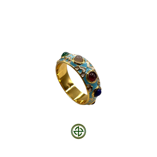 A gold-colored ring featuring a turquoise enamel band with embedded multicolored gemstones in a textured pattern.