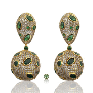 Pair of gold earrings with green gemstones on a white background