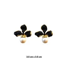A pair of pearl earrings with black zirconia accents, featuring a rose gold-plated band.