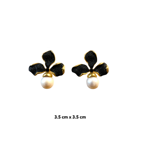 A pair of pearl earrings with black zirconia accents, featuring a rose gold-plated band.