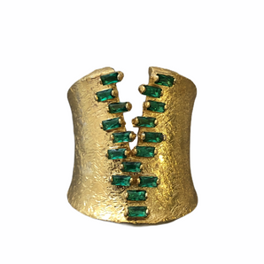 A gold vermeil ring with baguette green zirconia stones set in an oxidized texture design.