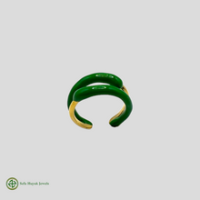 A two-tone gold and green enamel ring without stones, displayed against a white background.