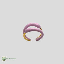 A two-tone gold and pink enamel ring without stones, displayed against a white background.